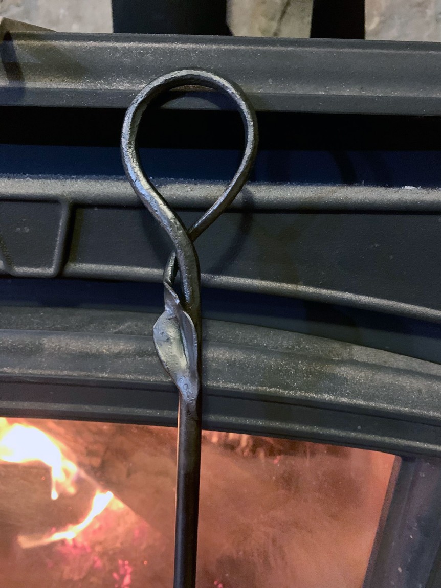 curled fire poker handle with leaf