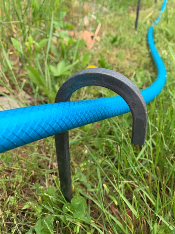 curled garden hose guides to catch the hose