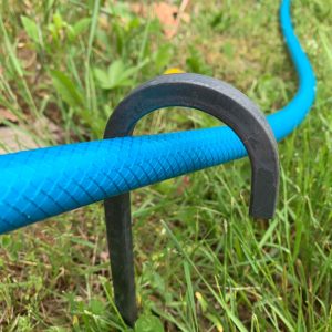 curled garden hose guides to catch the hose
